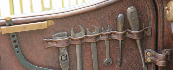 Toolkit for classic cars in brown leather, vintage looking tools including spanners, screwdrivers etc.